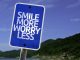 Smile More Worry Less sign scaled