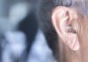 bigstock Hearing Aid In Ear 212550868 scaled