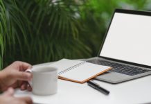 person holding white ceramic mug near macbook pro 3787808 scaled