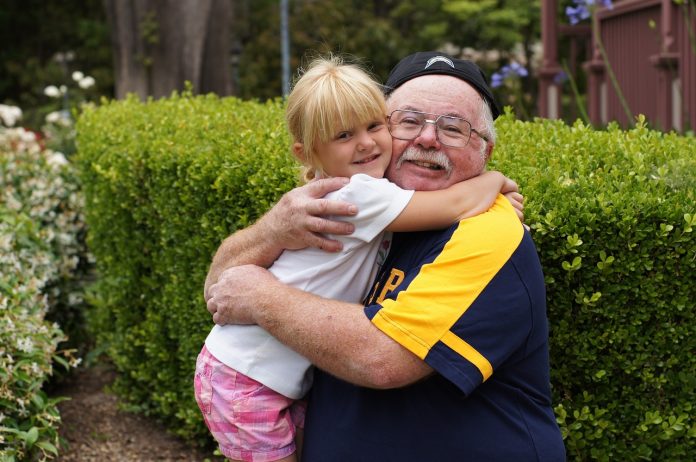 grandfather and girl are smiling