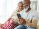 happy diverse senior couple using smartphone home shutterstock 1448949023 AM CL