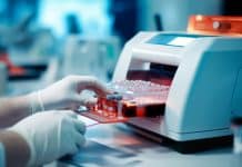 hand of researcher working with microplate for elisa analysis in machine. Doctor working with panel microplate for analysis and diagnostic in the laboratory.