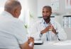 Doctor, patient and consultation with conversation for healthcare, people in office with advice or instructions for medication. Treatment, medical info and elderly care with communication at clinic