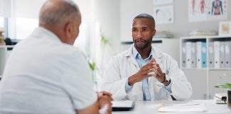Doctor, patient and consultation with conversation for healthcare, people in office with advice or instructions for medication. Treatment, medical info and elderly care with communication at clinic
